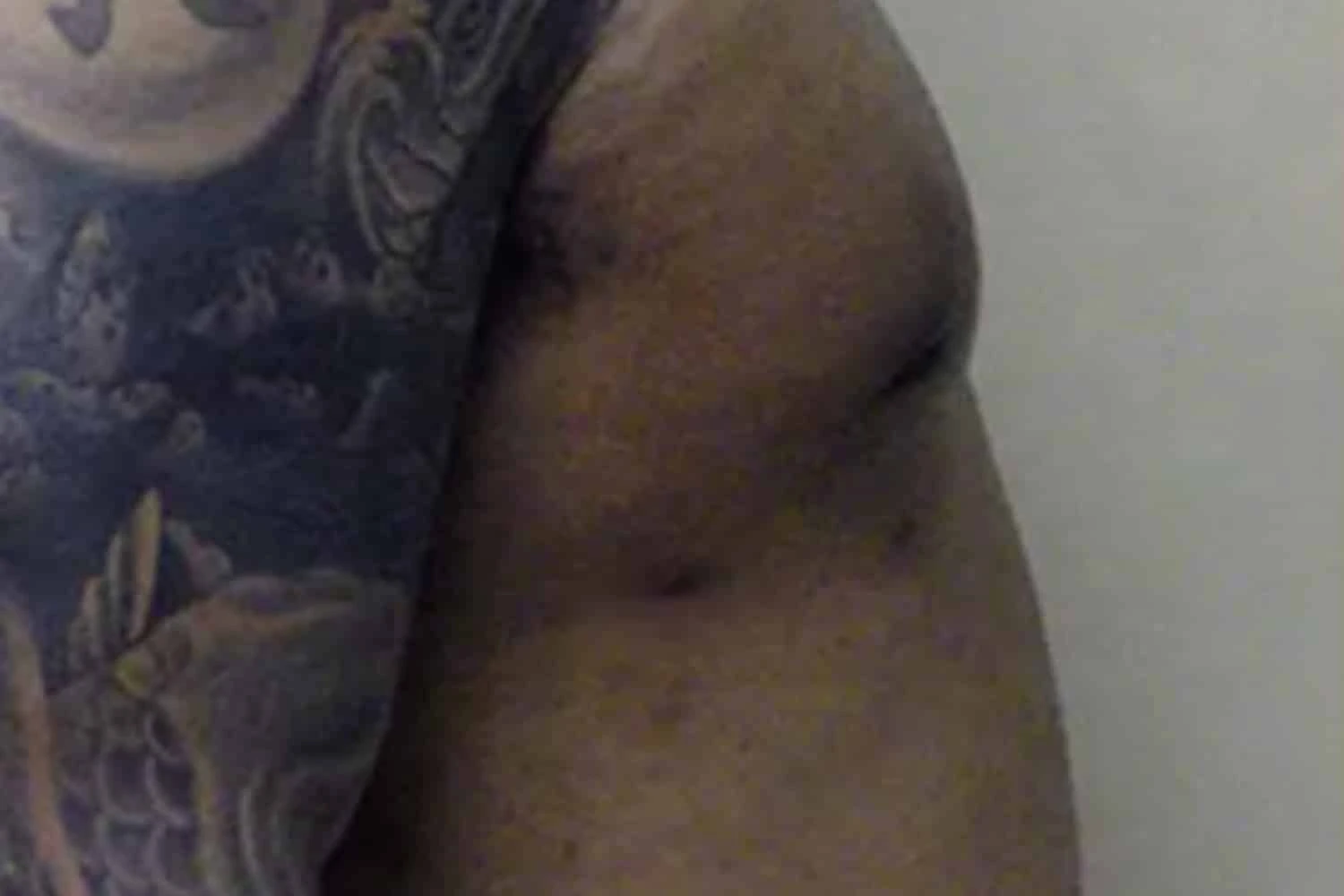 Male chest after body augmentation, side profile showing results